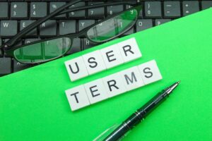 Terms Of Use | Laptop Keyboard, Pen, Glasses, White Compartment With The Words User Terms